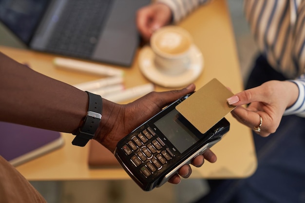 Unrecognizable woman paying via credit card