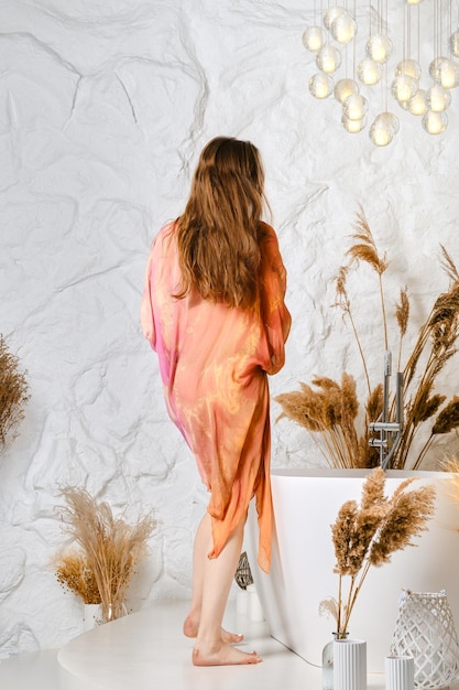 Unrecognizable woman preparing a bath in a spa