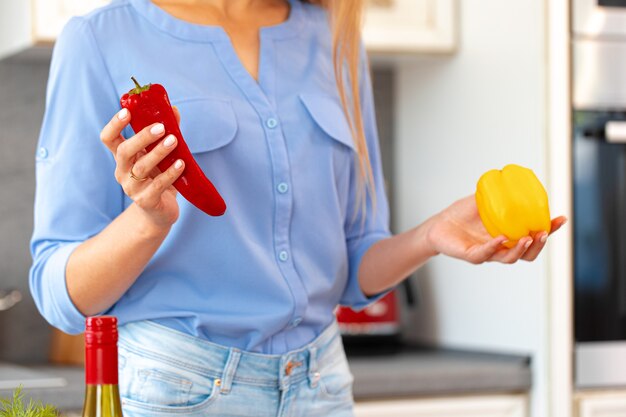 Unrecognizable woman standing in her kitchen close up