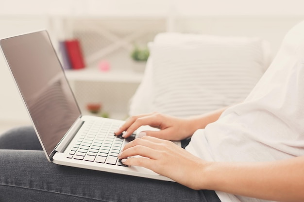 Unrecognizable woman typing on laptop closeup Job searching online remote work sending CV freelance concept copy space