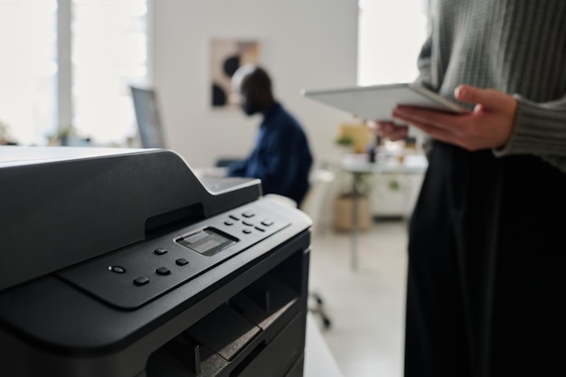 Photo unrecognizable woman using printer in office