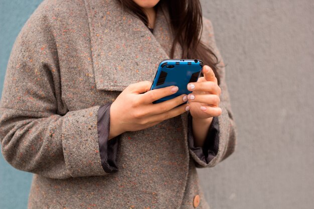 Unrecognizable  woman with cell phone