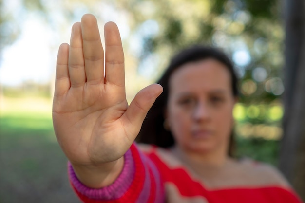 Photo unrecognizable woman with raised hand concept of stop