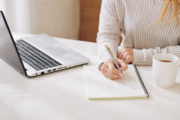 unrecognizable woman working at home
