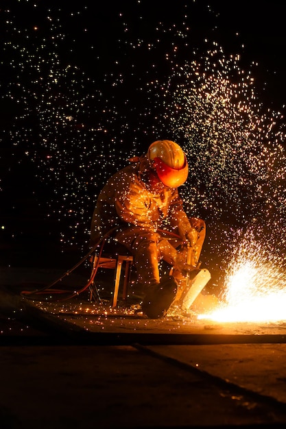 Unrecognizable worker in oxyacetylene fuel cutting process