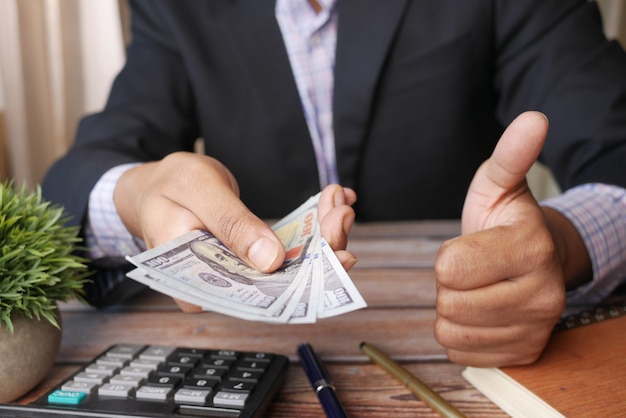 Unrecognized businessman hand counting  us dollar cash