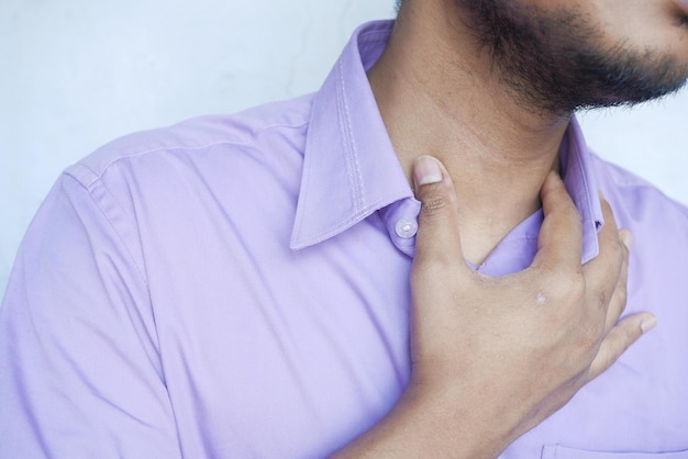 Unrecognized man suffering throat pain close up