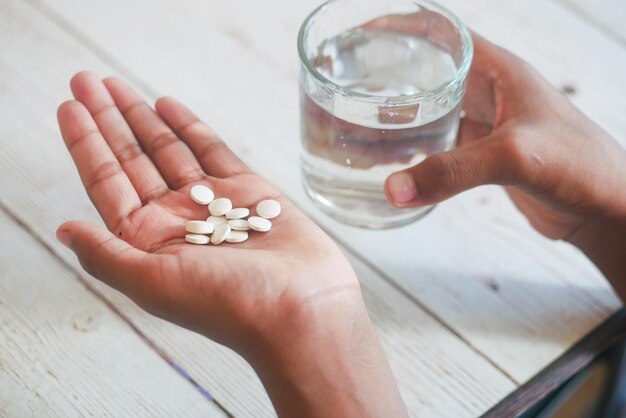 Unrecognized man in white shirt taking medicine