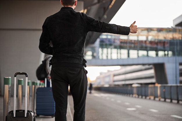 Unrecognized traveler catching the taxi after arrival