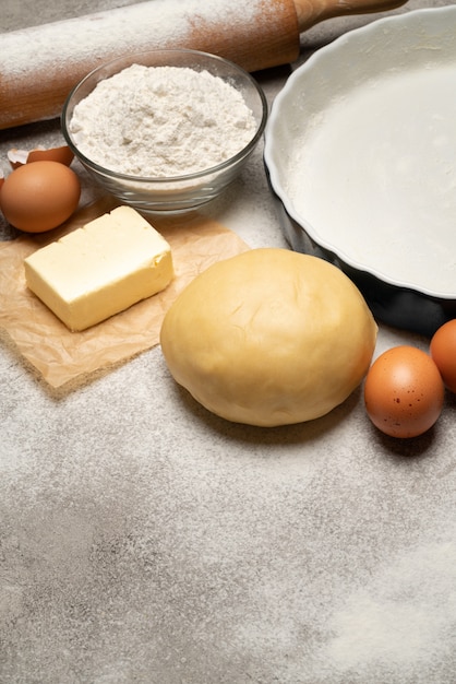 Unrolled and unbaked Shortcrust pastry dough recipe on concrete background