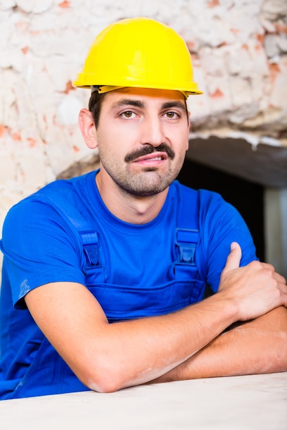 Unsatisfied construction worker on site grunting