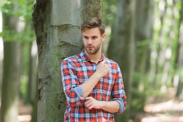 Unshaven sexy guy in forest human and nature