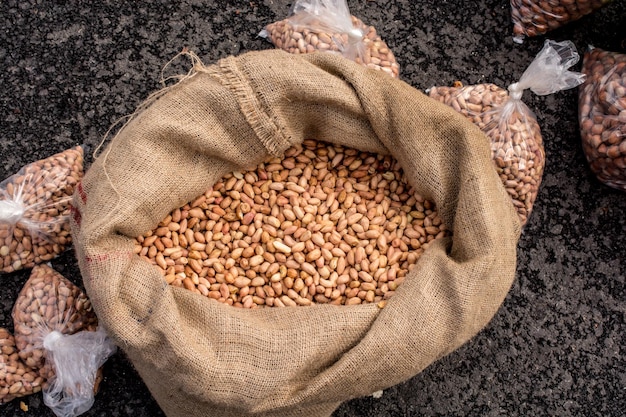 Unshelled peanuts in a straw sack on display