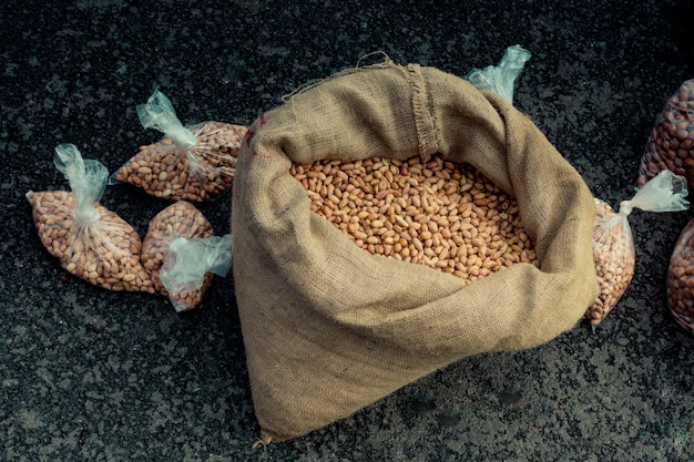 Unshelled peanuts in a straw sack on display