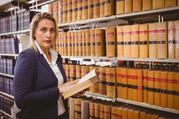 Unsmiling woman reading a book