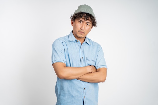 Unsure asian young man thinking on isolated background