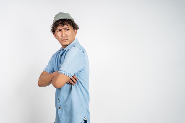 Unsure asian young man thinking on isolated background