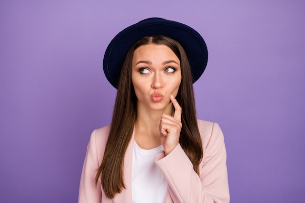 Unsure minded girl look copyspace touch finger cheek think thoughts cant decide fall weekend 14-february decision make lips plump wear trendy pastel clothes isolated purple color background