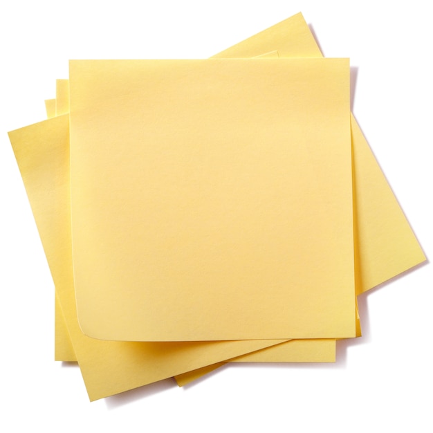 Untidy stack yellow sticky post notes isolated on white