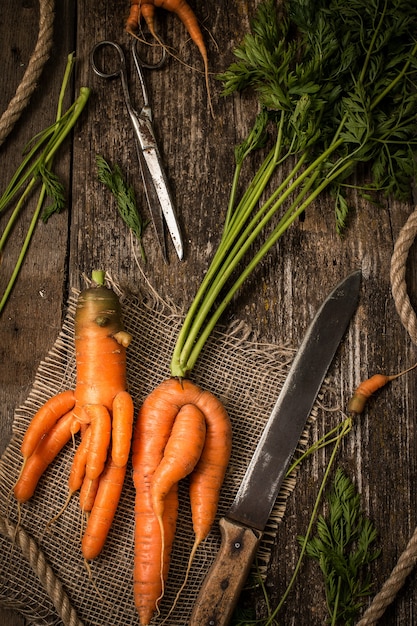 Unusual carrots on an old wooden table