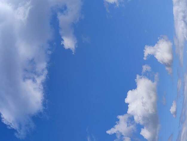 Unusual distorted white cloudscape over blue sky background