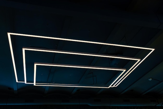 Unusual rectangular design lamps on the ceiling in an expensive restaurant Interior design in a cafe Lighting fixtures on the black ceiling