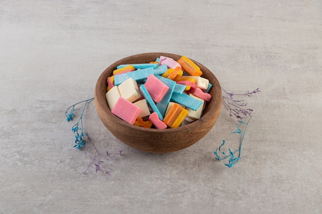 Unwrapped sugar free chewing gum sticks placed on a stone table .