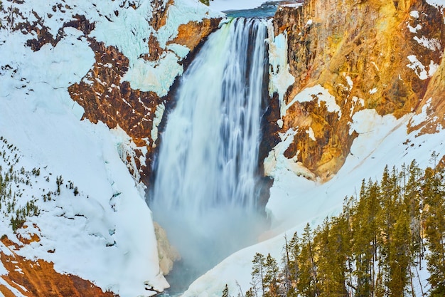 Up close to amazing Yellowstone Upper Falls in winter snow