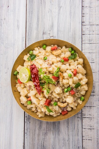 Upma or Uppittu is a popular breakfast dish in South India and Maharashtra. Semolina or Rava or coarse rice flour is main ingredients. Served in a bowl over colourful or wooden background