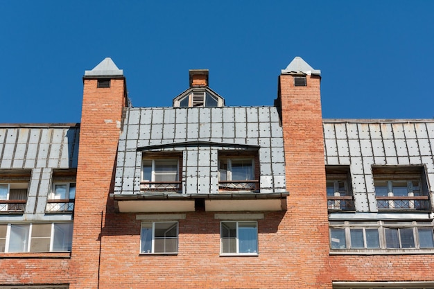 The upper floors of highrise buildings with roofs upholstered with sheet iron apartments