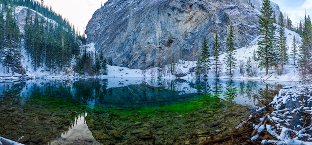 Upper Grassi Lakes in winter season. The reflection of the lake surface like a mirror. Canmore, Alberta, Canada.