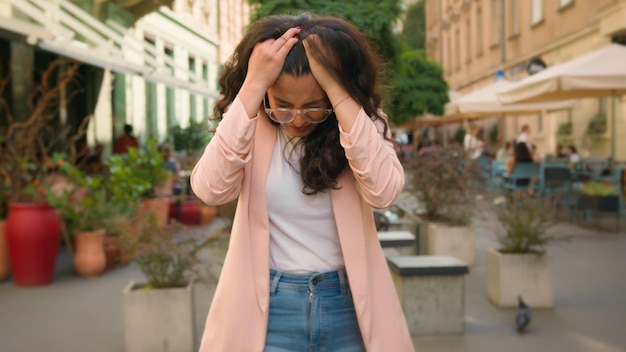 Photo upset angry mad woman indian arabian female girl businesswoman student suffer headache migraine