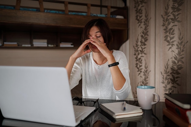 Upset asian woman working from home office