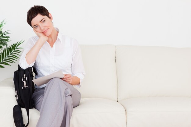 Upset Businesswoman with a paper and a bag