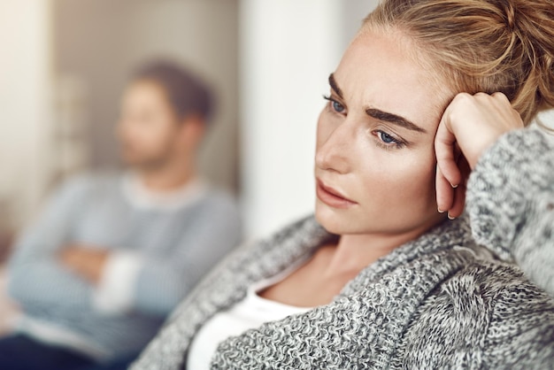 Photo upset depression and woman in argument with her boyfriend in the living room of their apartment sad disappointed and moody female person with conflict fight or breakup with partner at their home