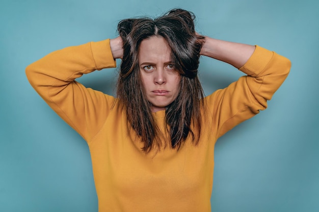 Photo upset disappointed woman holding head with tousled hair in hands depression family misunderstandings