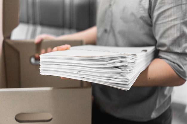 Upset employee packing belongings in box