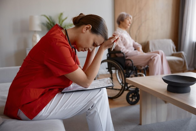 Upset frustrated doctor holding head leaned over patient card