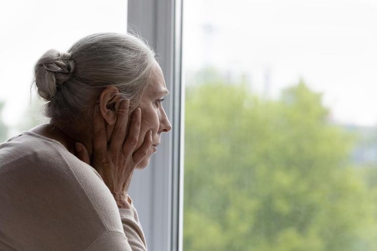 Photo upset lonely senior lady looking out of window with despair frustration going through depression apathy mental disorder thinking over health problems worried about memory loss dementia