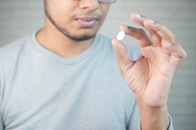 Upset man hand holding medical pills