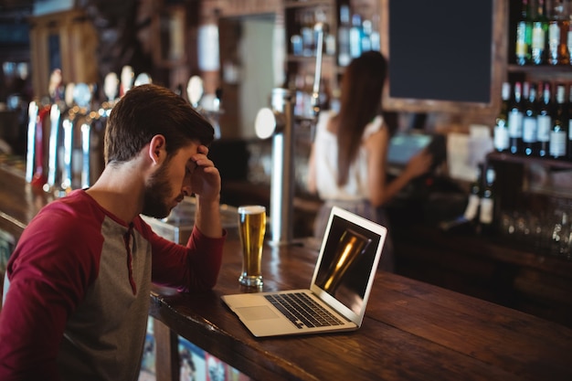 Upset man using laptop