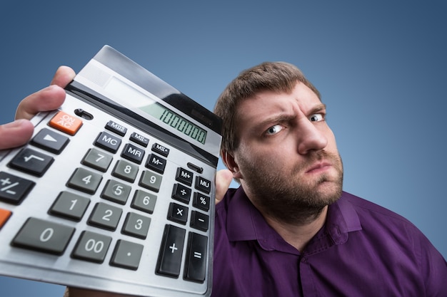 Upset man with calculator