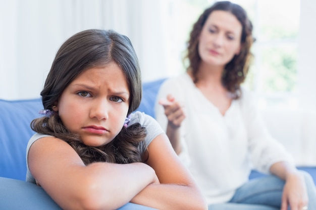 Upset mother looking at her daughter 