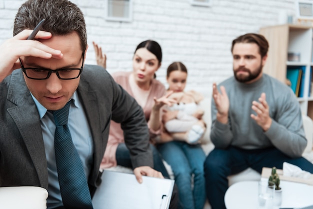 Upset Psychologist Thinking while Family Fighting