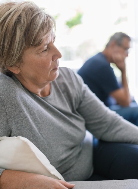 Upset senior couple at home having an argument