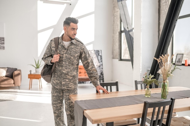 Upset serviceman saying good-bye to his house before leaving