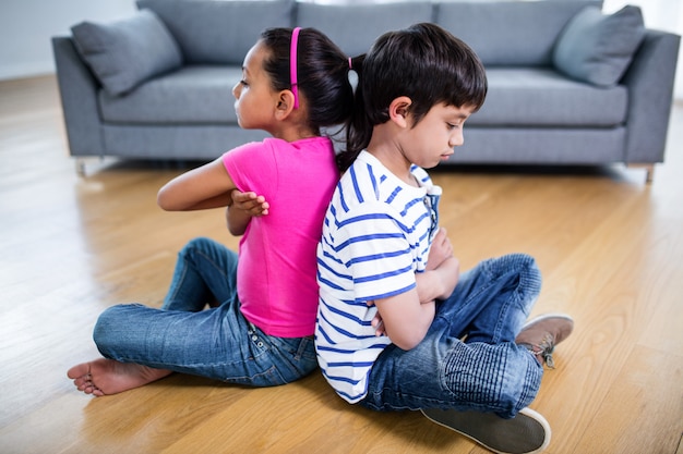 Photo upset siblings ignoring each other