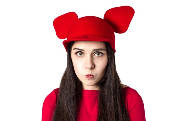 Upset white black haired beautiful young woman with mouse ears hat.