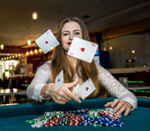 Upset woman in casino with falling cards