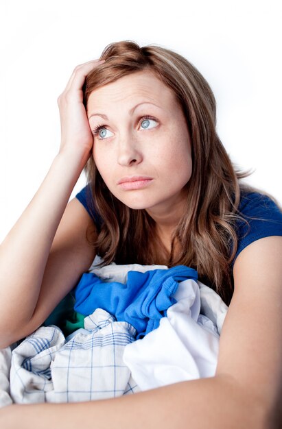 Upset woman doing laundry